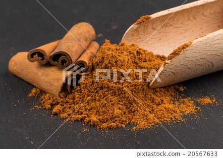 Cinnamon sticks with cinnamon powder on stone Cinnamon sticks with cinnamon powder on stone 20567633