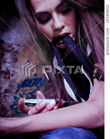 Portrait of woman addicted to syringe Portrait of woman addicted to syringe 20569602