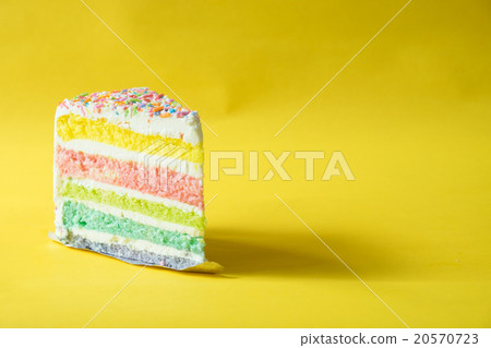 Rainbow butter cake over yellow background 20570723