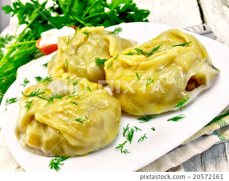 Manty with dill in dish on light board 20572161