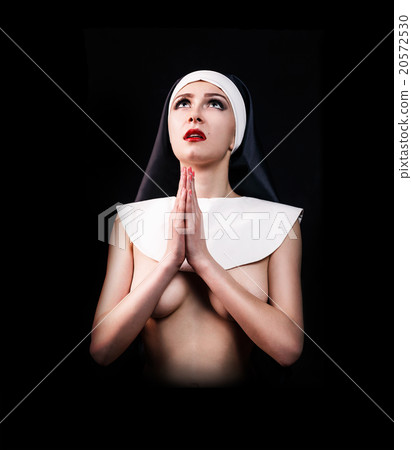 Young sexy woman nun praying  20572530