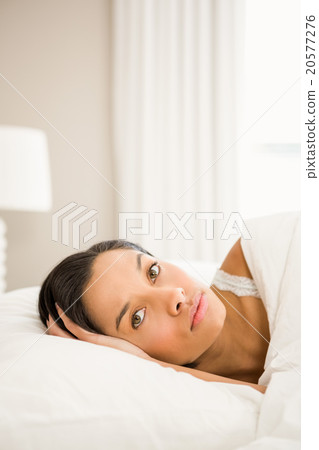Attractive brunette on bed Attractive brunette on bed 20577276