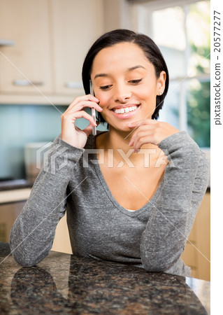Smiling brunette on a phone call Smiling brunette on a phone call 20577277