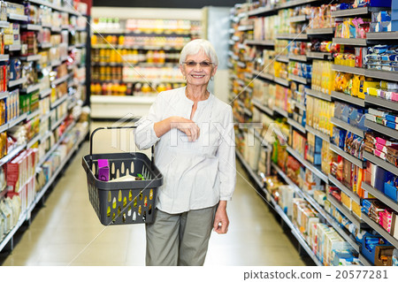Smiling senior woman with basket 20577281