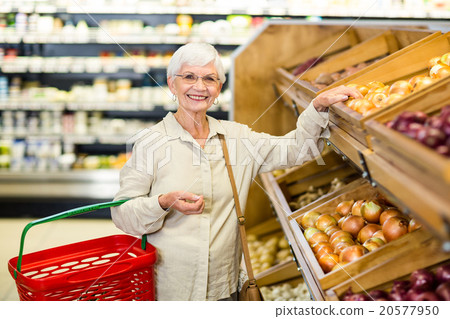 Senior woman picking out some vegetables 20577950