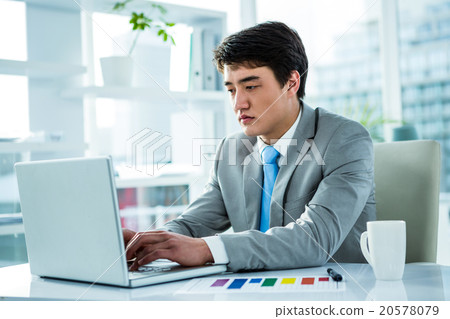 Asian businessman working in his computer 20578079