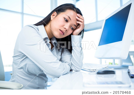 Thoughtful businesswoman with hand on face 20578468