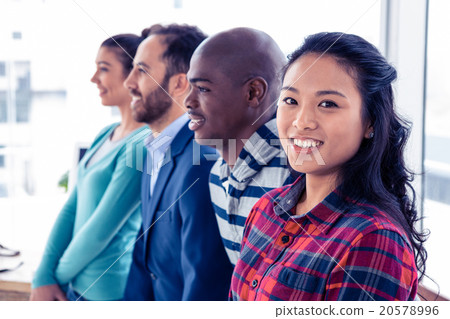 Portrait of young businesswoman standing with colleagues Portrait of young businesswoman standing with colleagues 20578996