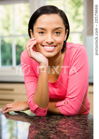 Portrait of smiling brunette in kitchen Portrait of smiling brunette in kitchen 20579666