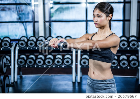 Fit woman exercising with dumbbells 20579667