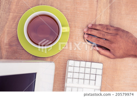 Businessman using mouse while working at table 20579974