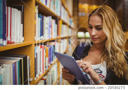Smiling student using her tablet Smiling student using her tablet 20580273