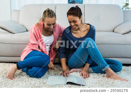 Friends reading on the carpet 20580278