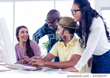 Business people laughing at desk Business people laughing at desk 20580447