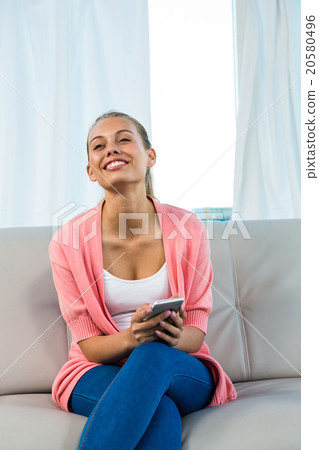 Smiling woman holding smartphone 20580496
