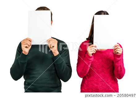 Couple hiding faces with documents 20580497