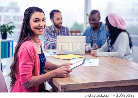 Portrait of cheerful young businesswoman holding digital tablet Portrait of cheerful young businesswoman holding digital tablet 20580582