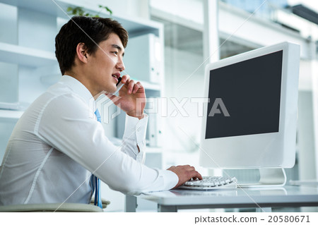 Asian businessman talking on the telephone Asian businessman talking on the telephone 20580671