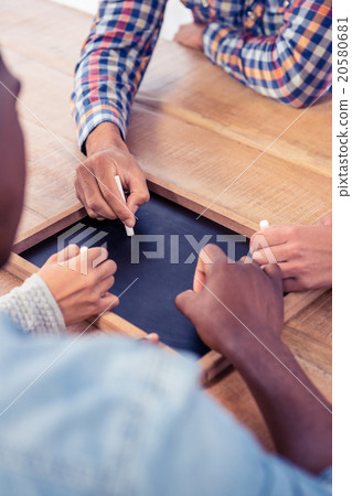 High angle view of business people writing on slate 20580681