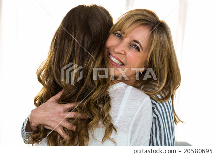 Mother and daughter hugging Mother and daughter hugging 20580695