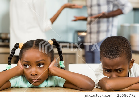 Sad siblings against parents arguing 20580772