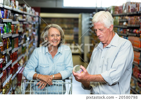 Smiling senior couple buying food Smiling senior couple buying food 20580798