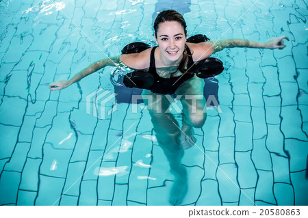 Fit smiling woman doing aqua aerobics 20580863