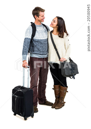 Full length of cheerful couple in warm clothing with luggag Full length of cheerful couple in warm clothing with luggag 20580945