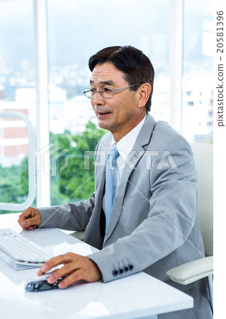 Asian businessman using his computer 20581396