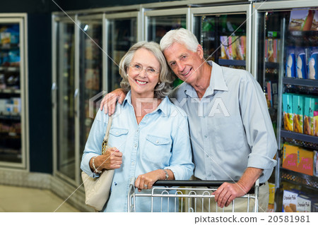 Smiling senior couple with cart Smiling senior couple with cart 20581981