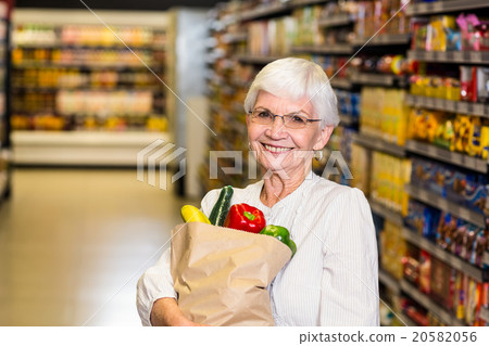 Portrait of smiling senior woman with grocery bag Portrait of smiling senior woman with grocery bag 20582056