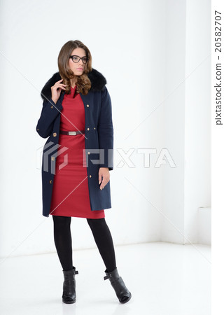 Girl in coat posing at studio 20582707