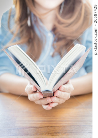 Close up woman hand holding pocket book to read. 20587429