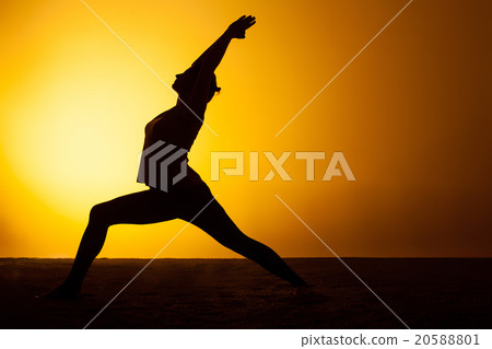 The woman practicing yoga in the sunset light 20588801