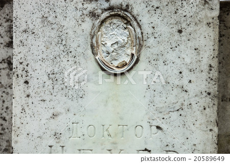 Old gravestone with damaged portrait Old gravestone with damaged portrait 20589649