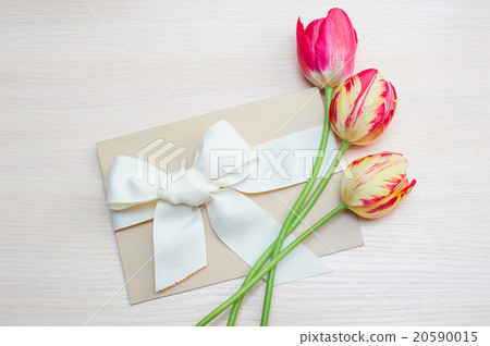 Tulips and greeting card with bow on a background 20590015