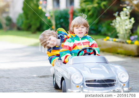 Two happy sibling boys playing with big old toy 20591708