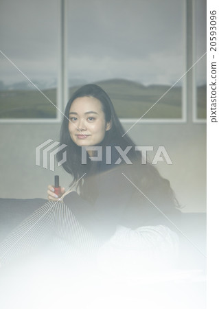 A woman relaxing on the sofa A woman relaxing on the sofa 20593096