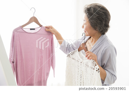 Senior woman choosing clothes Senior woman choosing clothes 20593901