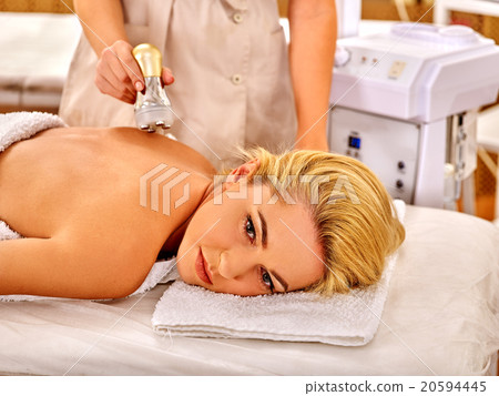 Young woman receiving electric back massage. 20594445