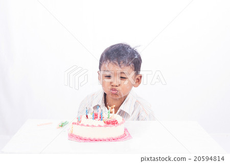 little asian boy blowing birthday cake little asian boy blowing birthday cake 20594814