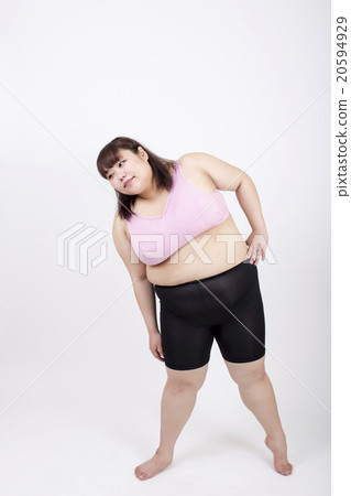 A fat young lady stretching his left hand to the side in front of a white background 20594929