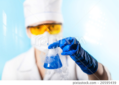 Woman chemist examines test tube Woman chemist examines test tube 20595439