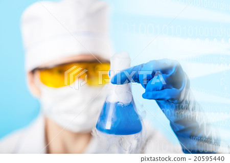 Woman chemist examines test tube Woman chemist examines test tube 20595440