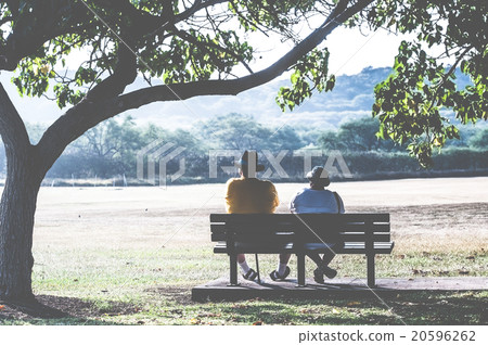An old couple sitting on a park bench An old couple sitting on a park bench 20596262