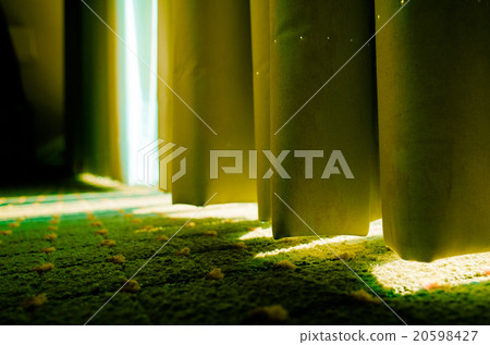 The light of the sun is leaking from the room curtain The light of the sun is leaking from the room curtain 20598427