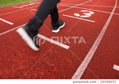 Red running racetrack on the stadium with run legs 20598655
