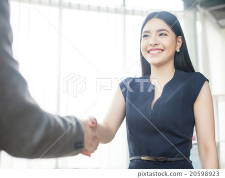 Stock Photo: Smart Asian woman smiling and shaking hand