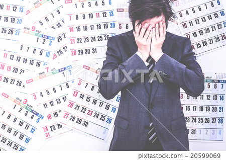 A businessman troubled in front of the calendar 20599069