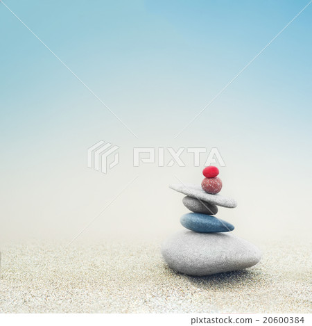 Balancing zen stones pyramid on sand Balancing zen stones pyramid on sand 20600384